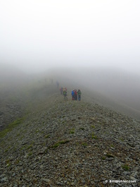 The hikers descend the scree