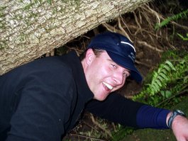 Jason clambors over the fallen tree