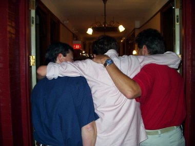 Andrew, who has eaten too much, is carried off by his dad and uncle