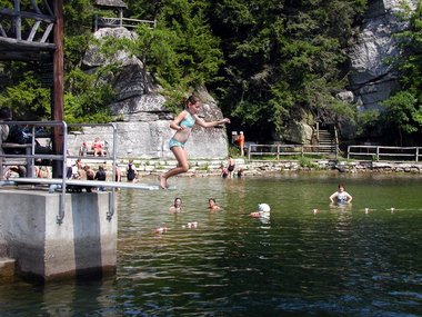 Julia jumps gingerly into the lake