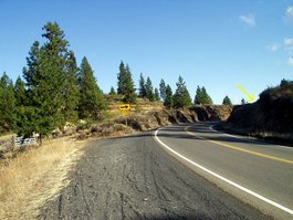 Approaching mark (on roadcut to left of road). Note gate on left, and old roadbed on right.