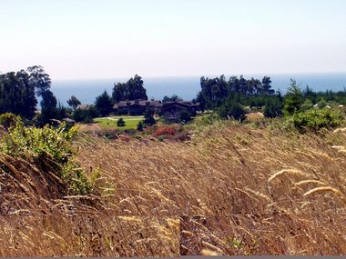 The lodge with the cabins on the left, the tents on the right, and the Pacific in the background