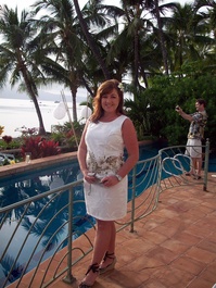 Angie poses on the patio, while Bill shoots in the background