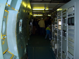 Racks of machines facing forward; behind me is the cargo door