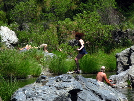Elizabeth takes the plunge from the rock
                            as Dan looks on