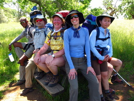 Weary hikers fight for a seat on the
                            picnic bench