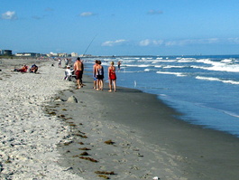 It was surreal&mdash;people fishing,
                                  walking, sunning, playing, while a
                                  rocket in the background (upper
                                  right) was being prepared for
                                  launch. And I was involved with it!