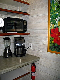 Enough appliances are provided to make coffee from whole beans, rum daiquiris, and grilled cheese