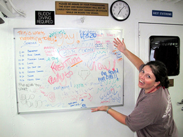 Blair poses in front of her and Kelli's masterpiece; note that Hector limited his brief to a small spot in the middle where the big, round, hard coral used to be (Photo by John Schwind)