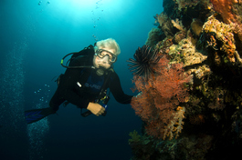 Bobby poses with a red gorgonian and feather star (Photo by John Schwind)