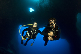 Lori and Bill descend through the famous Blue Holes (Photo by John Schwind)