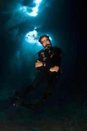 Ron poses in front of the Blue Holes (Photo by John Schwind)