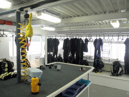 The diver stations around the camera table before the tanks and BCs have been transferred to the skiff for the week (Photo by Keith Hebert)