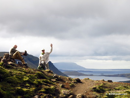 Robert waves while Charlie adjusts his boot