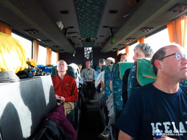 The hikers relax on the bus on the way to their next hotel after their hike and hot soak in the stream