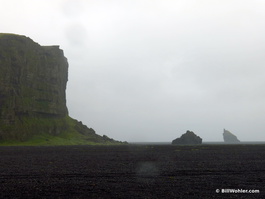 The vast, black sand beach
