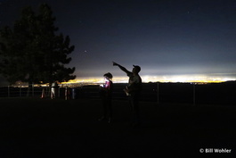 Stefan points out the planets Jupiter (shown), Saturn, and Mars to Paloma with the lights of San Jose behind