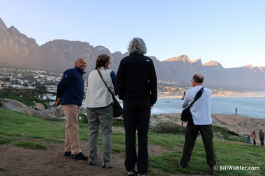 Edlein (our guide), Jeanne, Lori, and Dan watch the sun rise over Camp's Bay