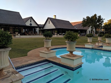 The pool, bar (left), reception (center), and restaurant (right) at the Royal Livingstone
