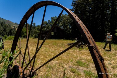 A wheel outside the barn
