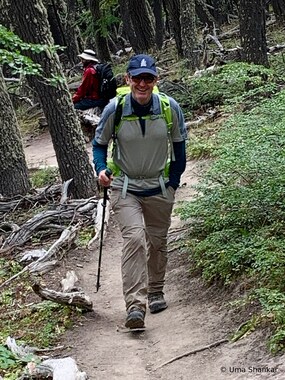 Uma snaps a shot of me hiking through a forest (photo by Uma Shankar)