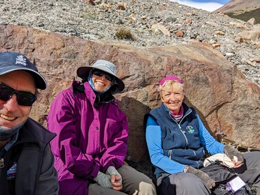 Lori, Christine, and I take refuge from the wind while we eat our lunch. Again.