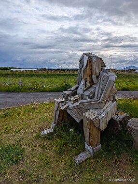 A sculpture of a man gutting a fish outside the Berjaya M&yacute;vatn Hotel