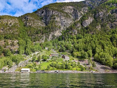 An old s&aelig;tra perched precariously above the Geirangerfjord