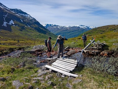 Mats assists Lori over this collapsed bridge while Dan looks on.