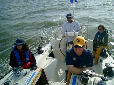 Spinnaker douse: foredeck gets the sail wet, the afterguard laughs